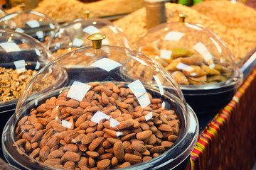 Raw almond kernels and other nuts on a store counter. 