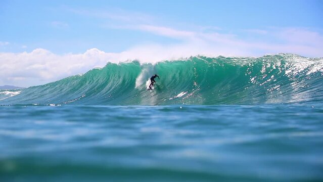 Slow Motion Shot Of Tourists Surfing On High Ocean Waves Against Sky During Sunny Day In Summer - Waikiki, Hawaii