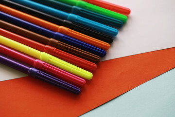 Fototapeta premium Colorful Crayons and flomasters on paper background stock photo