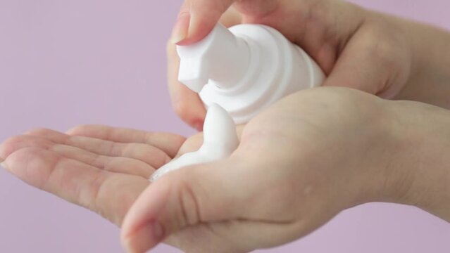 Facial foam, face cleanser, beauty skincare cosmetic, face wash mousse in a woman's hand