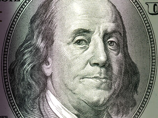 Macro close up of Ben Franklin's face on the US $100 dollar bill.