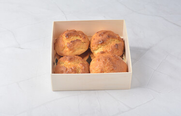 gourmet freshly bake golden Texas sweet original honey biscuit bun cake scone milk butter bread in square bento wood box on white marble table rose gold fork knife pastry halal dessert vegan menu