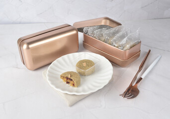 mini bake luxury tart in Japanese matcha hojicha green tea crisp with cranberry pineapple jam paste inside shining rose gold bronze iron box packaging on white marble pastry dessert halal party menu
