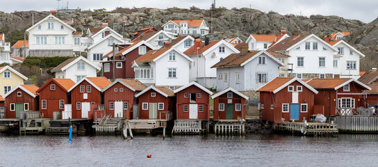 Swedish fishing village H&auml;lleviksstrand with red and white houses near the sea