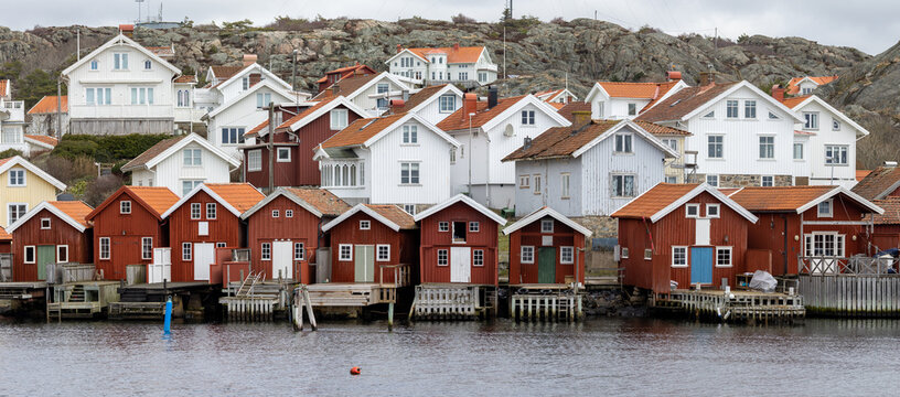 Swedish fishing village H&auml;lleviksstrand with red and white houses near the sea