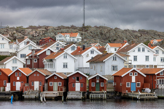 Swedish fishing village H&auml;lleviksstrand with red and white houses near the sea