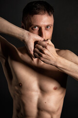 Obraz premium Adult attractive man with a beautiful body posing in the studio. Black background.