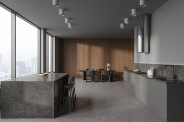 Gray and wooden kitchen interior with bar and table