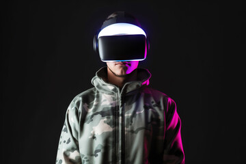 a man wearing a virtual reality headset with neon light isolated on black background