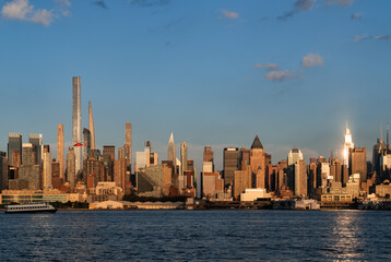 Fototapeta na wymiar New York Manhattan skyline at sunset, business skyscrapers and golden hour