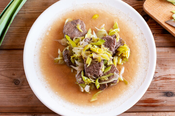 Meat medallions with leek. Pork medallions. Roasted pork fillet. Main course - Meat steak from pork on plate.