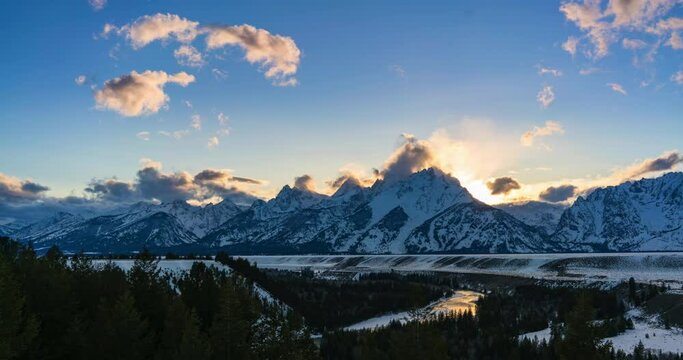 Timelapse Lockdown Of A Wintery Snowcapped Mountain Range And Passing Clouds At Sunset - Jackson Hole, Wyoming