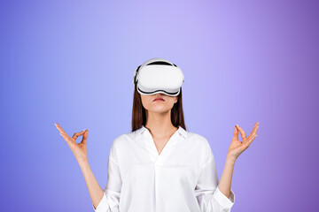 Woman in VR goggles meditating, purple