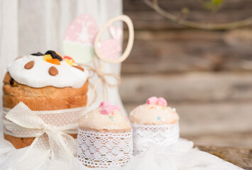 Easter cake with candied fruits and Easter decor on a wooden background . The concept of a holiday card. Close-up. Selective focus. Place for text