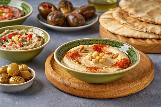 Middle eastern, arabic traditional breakfast with hummus, foul, mutabbal, makdous . Closeup
