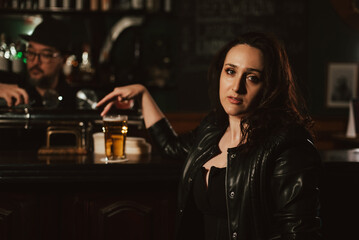 Plakat sad woman with a glass of draft beer at bar counter in pub
