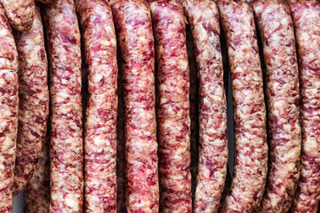 Traditional food. Homemade dry-cured sausage in a butcher's shop. Pork and beef sausages.