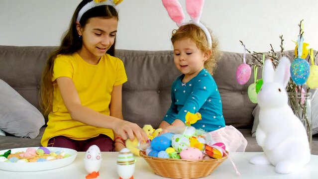 Easter table eggs and decor and children. Selective focus.