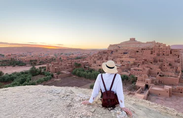Zelfklevend Fotobehang Ait Ben Haddou in the Atlas mountains of Morocco and woman tourist looking at the view © minoandriani
