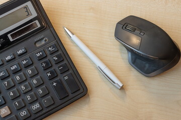 calculator and pen on table