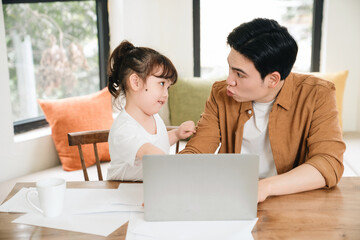 Image of Asian father and daughter at home