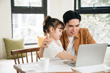 Image of Asian father and daughter at home