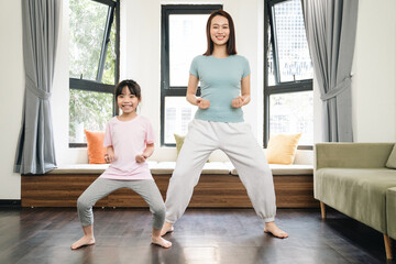 Asian mother and daughter exercise at home