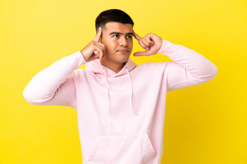 Fototapeta na wymiar Young handsome man over isolated yellow background having doubts and thinking