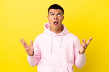 Young handsome man over isolated yellow background stressed overwhelmed