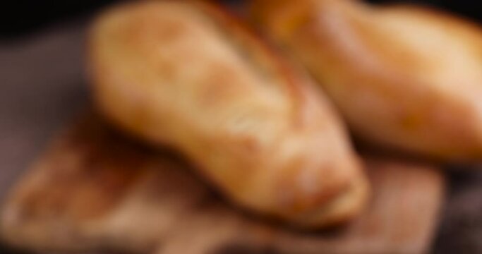 focus on a loaf of wheat bread, a loaf of fresh bread on the table