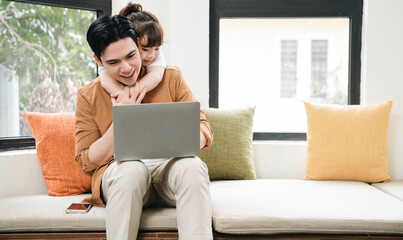 Image of Asian father and daughter at home