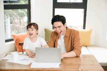 Image of Asian father and daughter at home