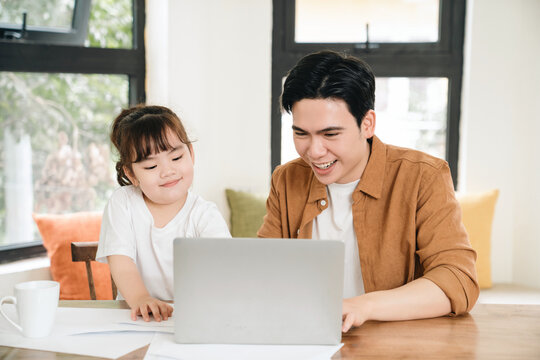Image of Asian father and daughter at home
