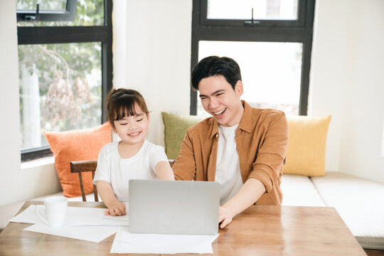 Image of Asian father and daughter at home
