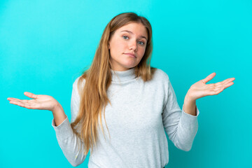 Young blonde woman isolated on blue background making doubts gesture