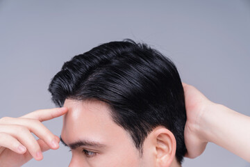 Image of young Asian man hair care on background - Powered by Adobe