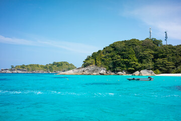 Fototapeta na wymiar Tropical island of Andaman coast with turquoise and clear blue waters against blue sky.