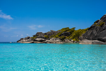 Fototapeta premium Tropical island of Andaman coast with turquoise and clear blue waters against blue sky.