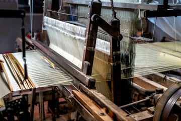 Van Phuc silk weaving village, Ha Noi, Viet Nam - Close-up picture of silk weaving machine in Van Phuc village. Van Phuc village is famous for the traditional silk weaving village