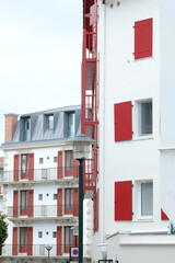 Obraz premium Saint-Jean de Luz, France - July 8th, 2023: The facades of the building of Saint-Jean de Luz in the french basque country.
