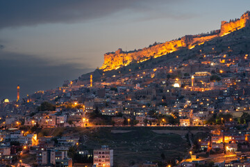 Panoramic view of Mardin at night with the citadel