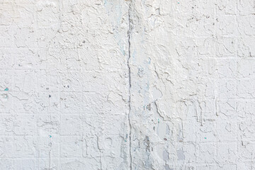 abstract background of an old shabby painted white tiled concrete wall close up