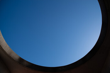 円形の穴から見上げる青空