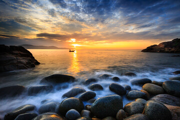 Long exposure of sea and stones, beautiful sunrise in Quy Nhon city, Vietnam