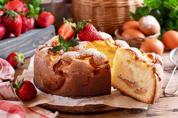 Homemade pie with apples and strawberriest on wooden table. Summer, bright, delicious pies with berry