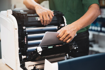 Technician hand open cover photocopier or photocopy to fix repair copier paper jam and replace ink...