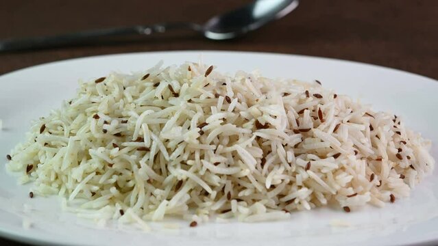 Serving jeera rice in a plate.