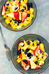 Bright fruit salad with field pansies.