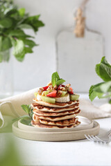 Pancakes with berries, fruits and mint.