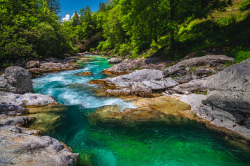 Emerald color Soca river with rocky shoreline, Bovec, Slovenia